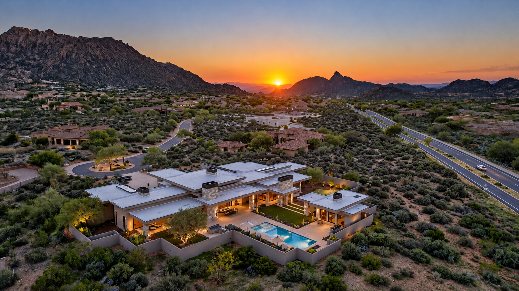Aerial view of Collina in Scottsdale, Arizona with its pool and courtyard at sunset beneath the surrounding mountains