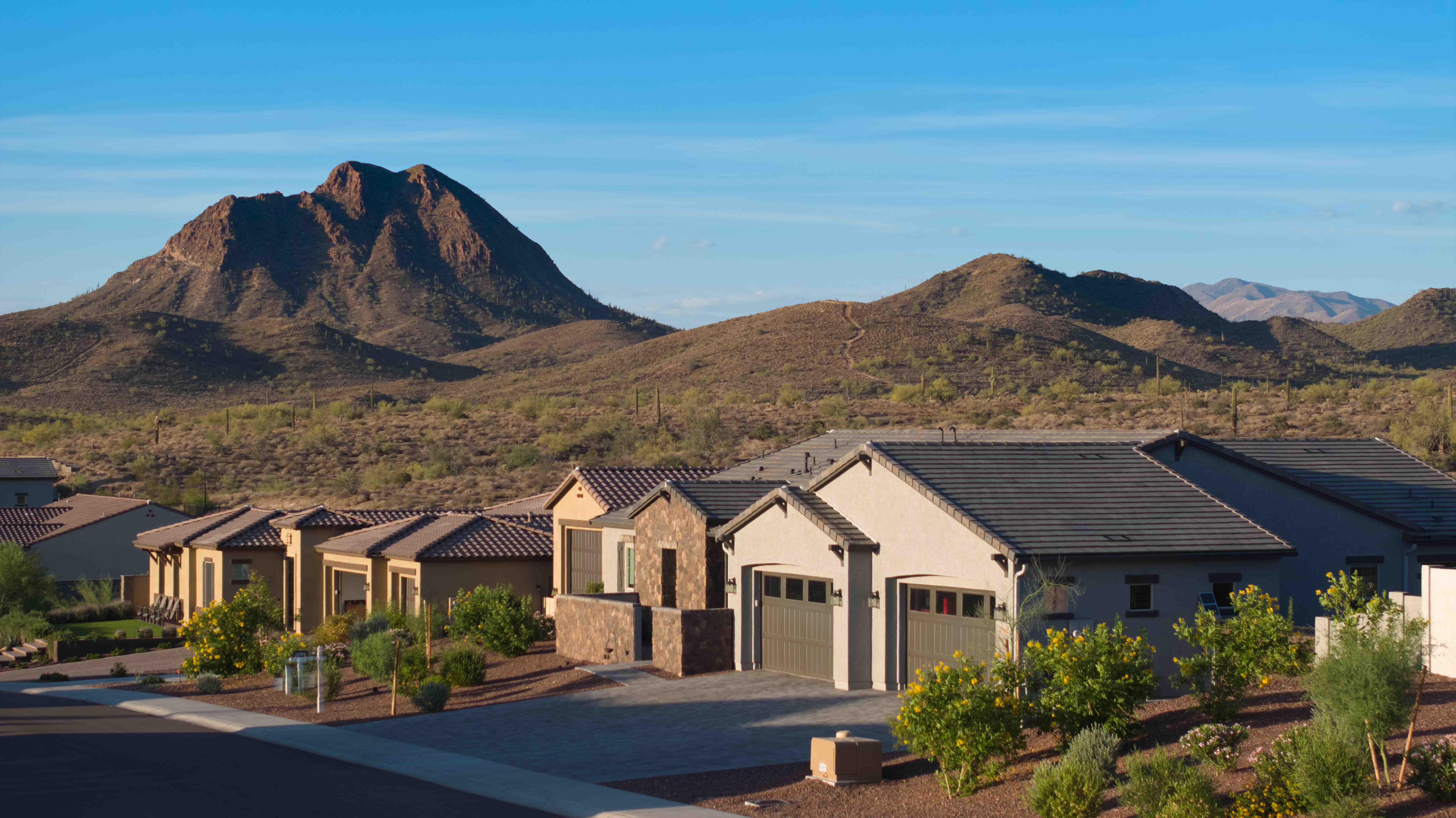 Listing Haus photograph of 43423 N National Ct in Anthem, Arizona — a single-story desert home with tile roof and paver driveway set against the rugged foothills