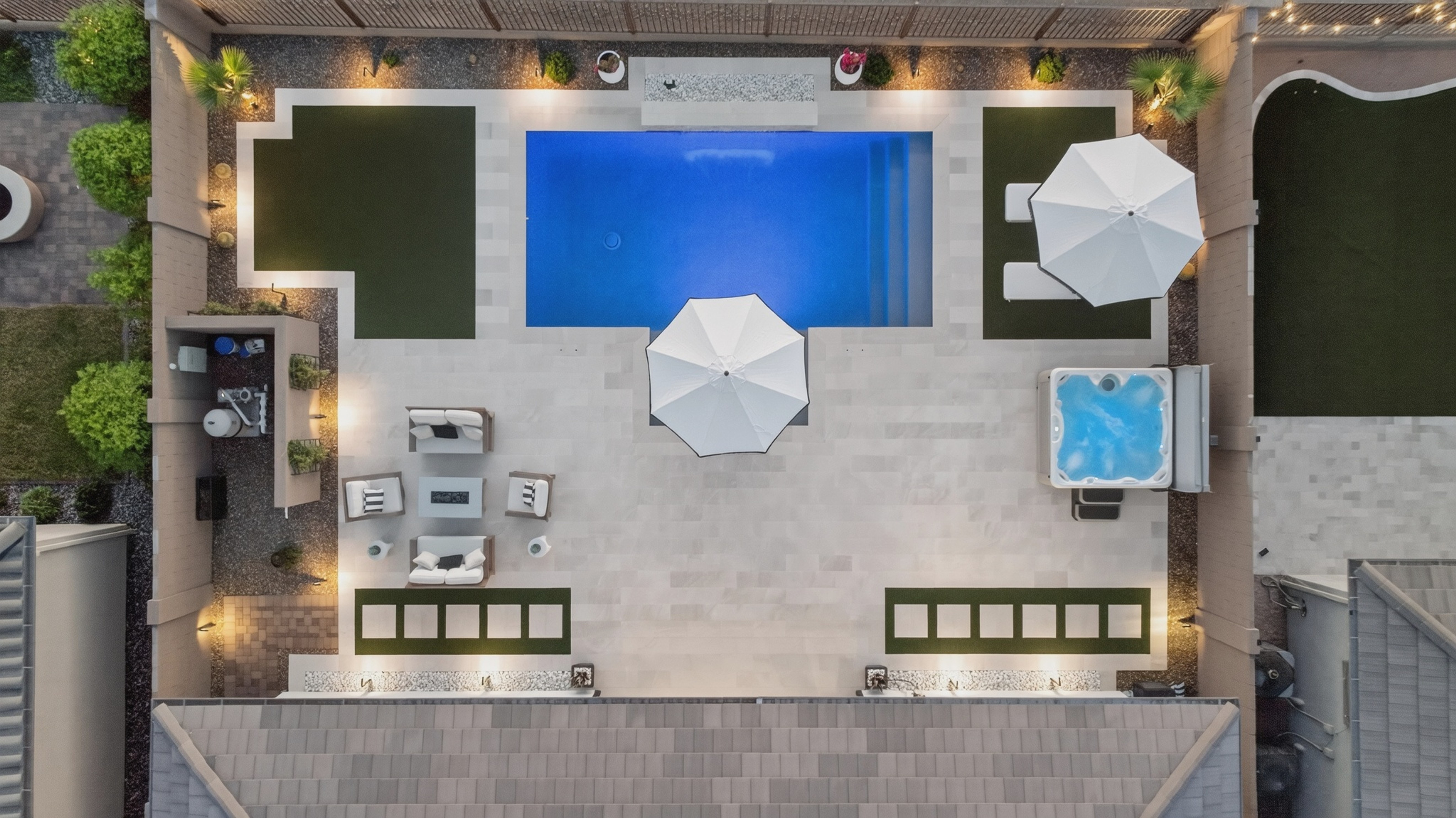 Straight-down aerial photograph of the property's backyard, pool, spa, patio and umbrellas